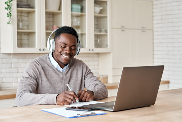 Person at a laptop listening to music